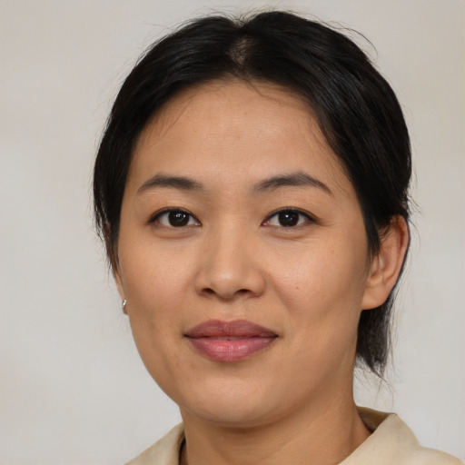 Joyful asian young-adult female with medium  brown hair and brown eyes