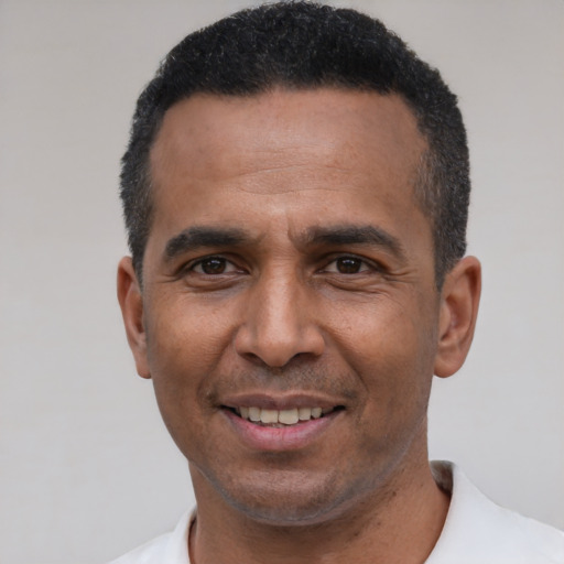 Joyful latino adult male with short  black hair and brown eyes