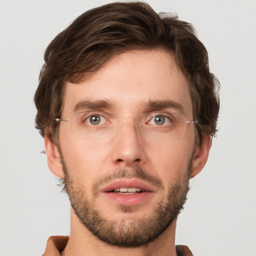 Joyful white young-adult male with short  brown hair and green eyes