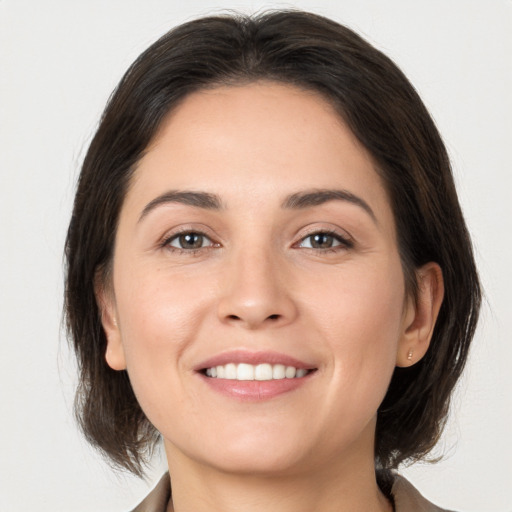 Joyful white young-adult female with medium  brown hair and brown eyes