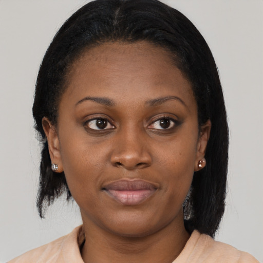 Joyful black young-adult female with medium  brown hair and brown eyes