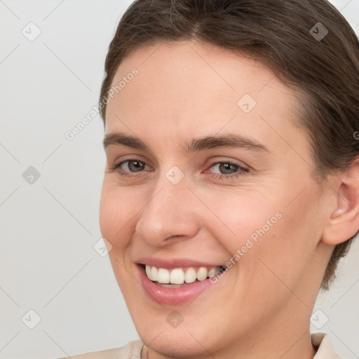 Joyful white young-adult female with short  brown hair and brown eyes