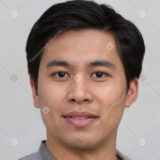 Joyful asian young-adult male with short  black hair and brown eyes