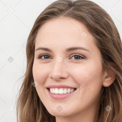 Joyful white young-adult female with long  brown hair and green eyes