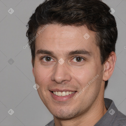 Joyful white adult male with short  brown hair and brown eyes