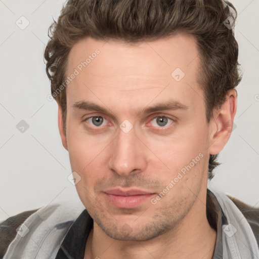 Joyful white adult male with short  brown hair and grey eyes