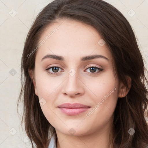 Joyful white young-adult female with long  brown hair and green eyes