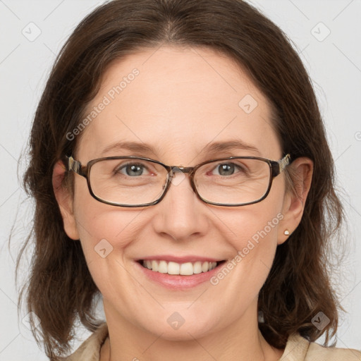 Joyful white adult female with medium  brown hair and grey eyes