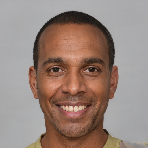 Joyful latino adult male with short  black hair and brown eyes