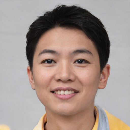 Joyful asian young-adult male with short  brown hair and brown eyes