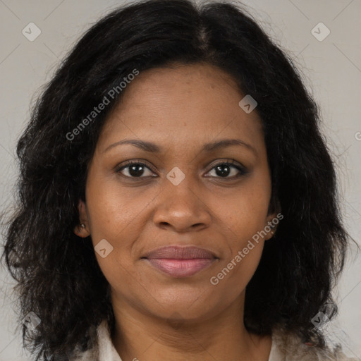 Joyful black adult female with medium  brown hair and brown eyes