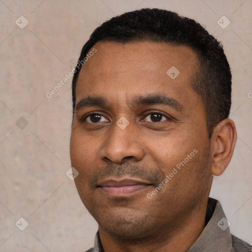 Joyful black young-adult male with short  black hair and brown eyes