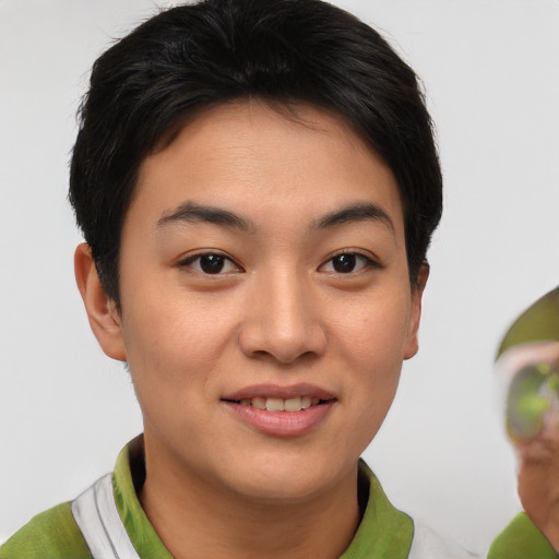 Joyful asian young-adult female with short  brown hair and brown eyes