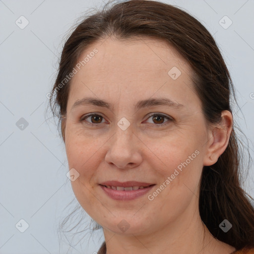 Joyful white adult female with long  brown hair and brown eyes