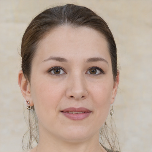 Joyful white young-adult female with medium  brown hair and grey eyes