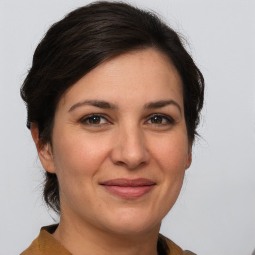 Joyful white adult female with medium  brown hair and brown eyes