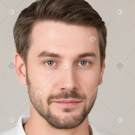 Joyful white young-adult male with short  brown hair and grey eyes