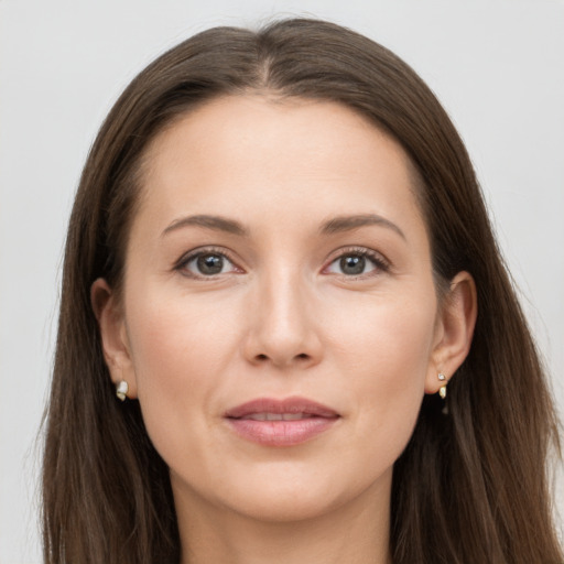 Joyful white young-adult female with long  brown hair and grey eyes