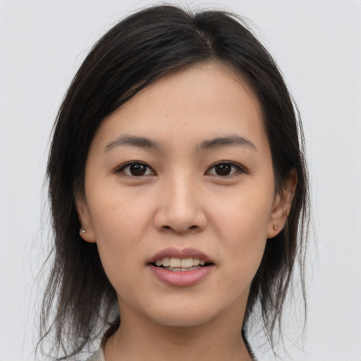 Joyful asian young-adult female with medium  brown hair and brown eyes