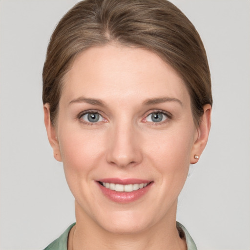 Joyful white young-adult female with short  brown hair and grey eyes