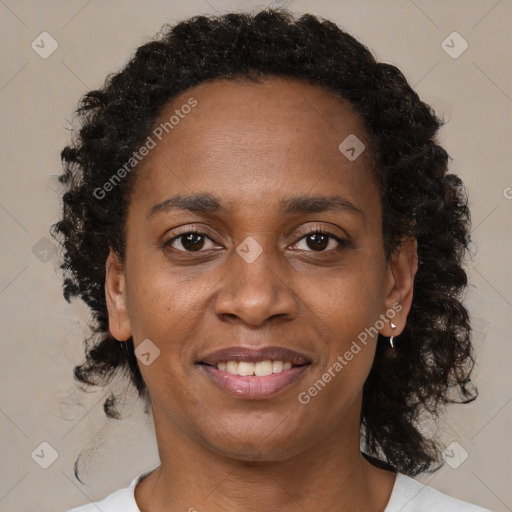 Joyful black adult female with medium  brown hair and brown eyes