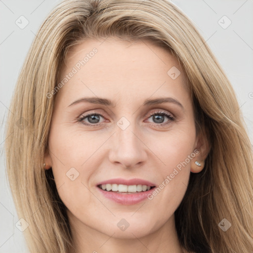 Joyful white young-adult female with long  brown hair and blue eyes