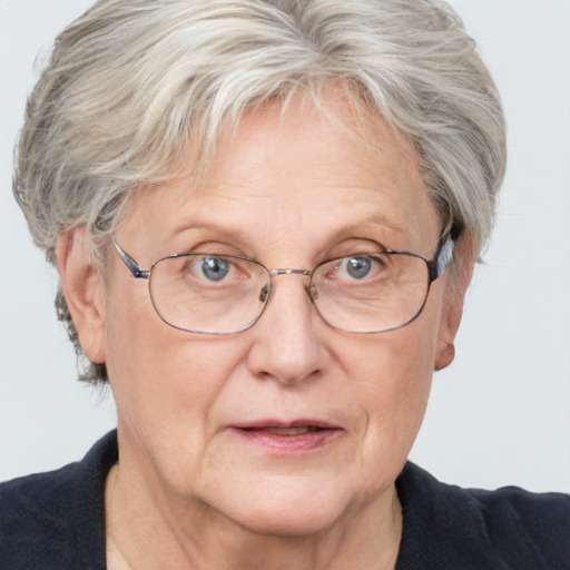 Joyful white middle-aged female with short  gray hair and blue eyes
