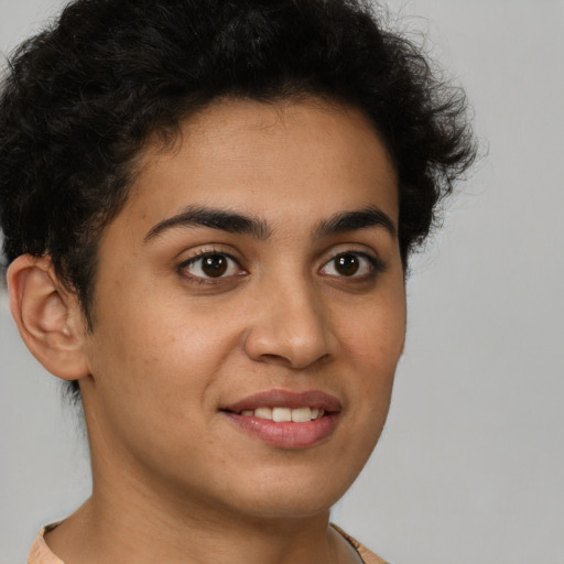 Joyful latino young-adult male with short  brown hair and brown eyes