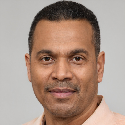 Joyful latino adult male with short  black hair and brown eyes