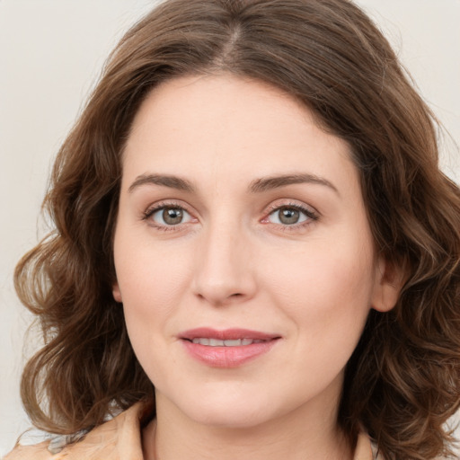 Joyful white young-adult female with medium  brown hair and green eyes