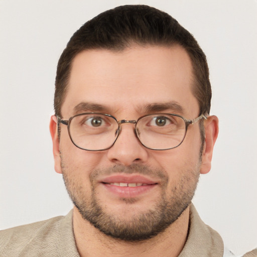 Joyful white young-adult male with short  brown hair and green eyes