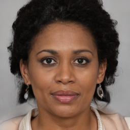Joyful black adult female with medium  brown hair and brown eyes