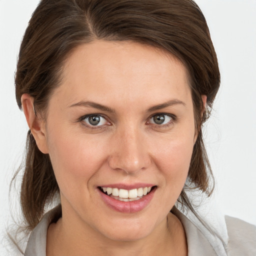 Joyful white young-adult female with medium  brown hair and brown eyes