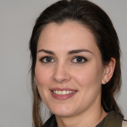 Joyful white young-adult female with medium  brown hair and brown eyes