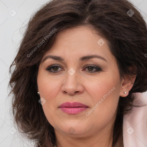 Joyful white adult female with long  brown hair and brown eyes