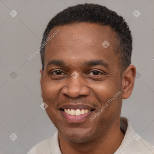 Joyful black adult male with short  black hair and brown eyes