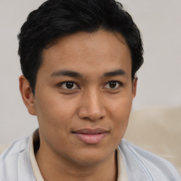 Joyful latino young-adult male with short  brown hair and brown eyes