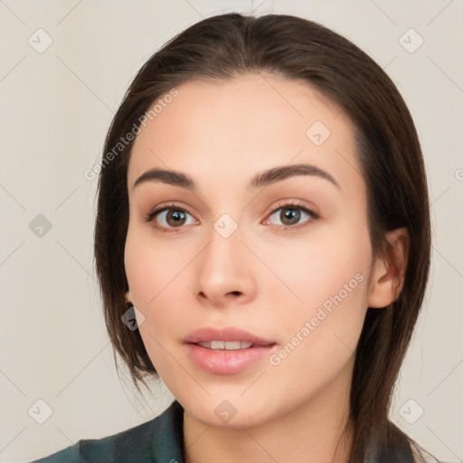 Neutral white young-adult female with long  brown hair and brown eyes