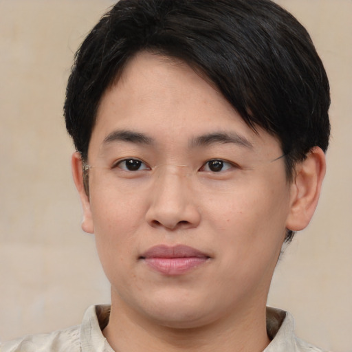 Joyful asian young-adult male with short  brown hair and brown eyes