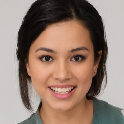 Joyful latino young-adult female with medium  brown hair and brown eyes