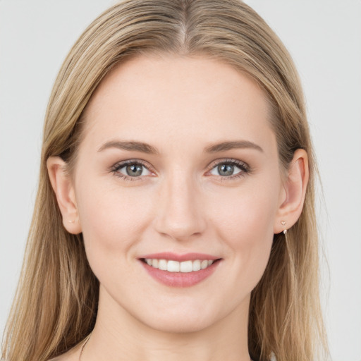 Joyful white young-adult female with long  brown hair and green eyes