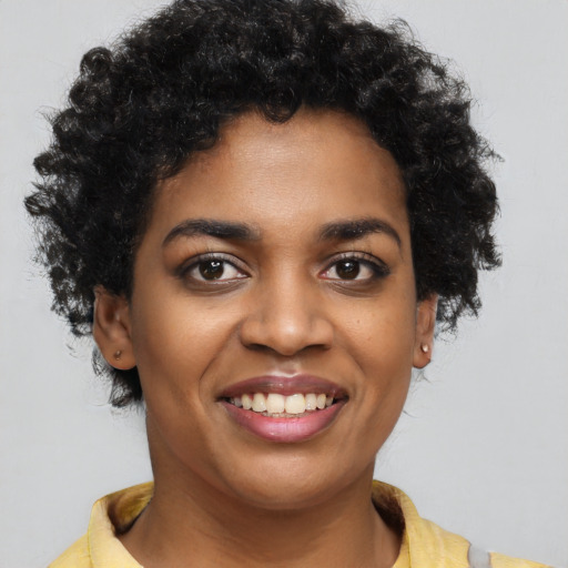 Joyful black young-adult female with short  brown hair and brown eyes