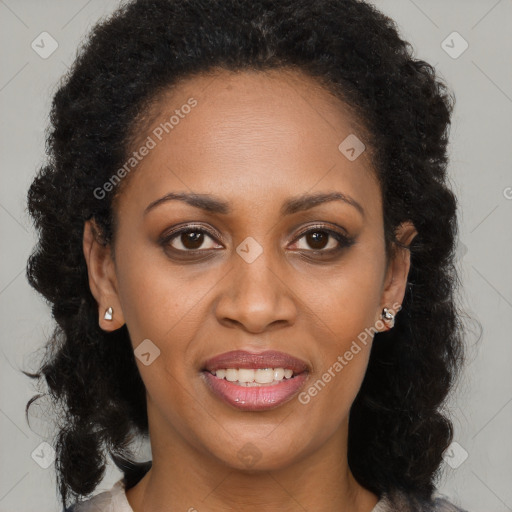 Joyful black young-adult female with long  brown hair and brown eyes