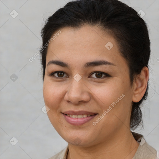 Joyful latino young-adult female with medium  brown hair and brown eyes