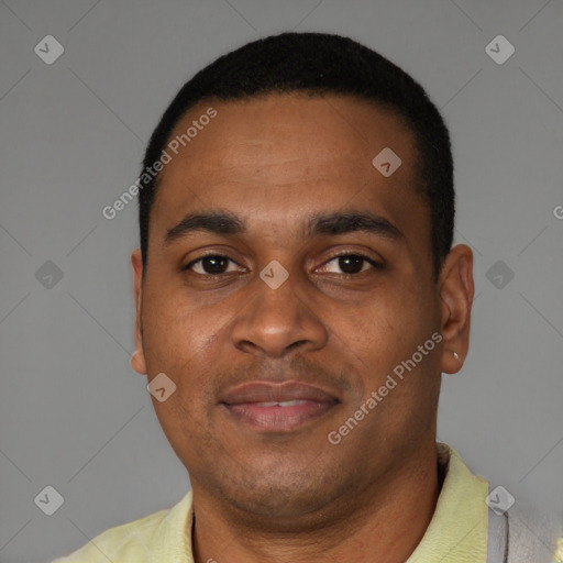 Joyful black young-adult male with short  brown hair and brown eyes