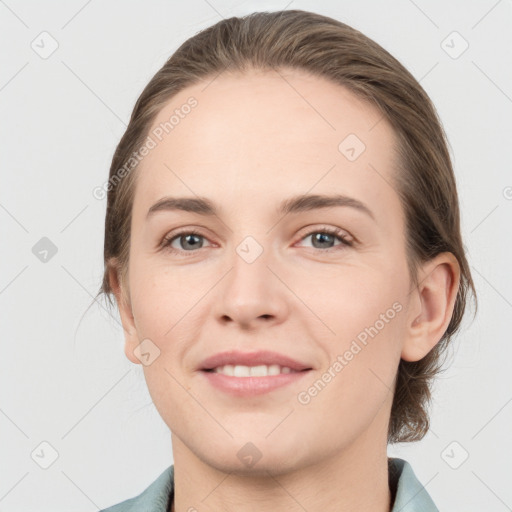 Joyful white young-adult female with medium  brown hair and grey eyes