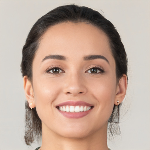 Joyful white young-adult female with medium  black hair and brown eyes