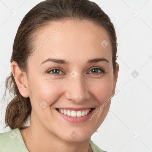 Joyful white young-adult female with medium  brown hair and grey eyes