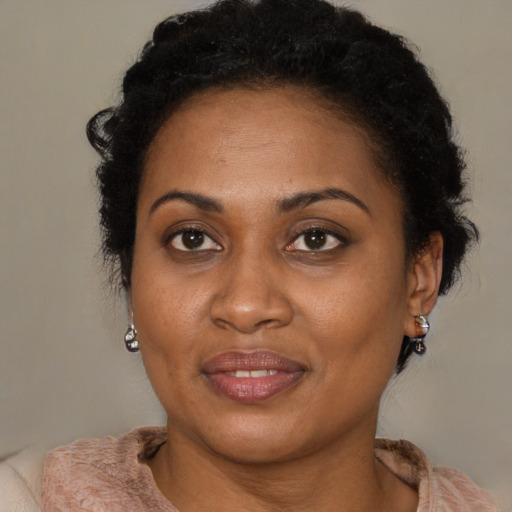 Joyful black adult female with short  brown hair and brown eyes