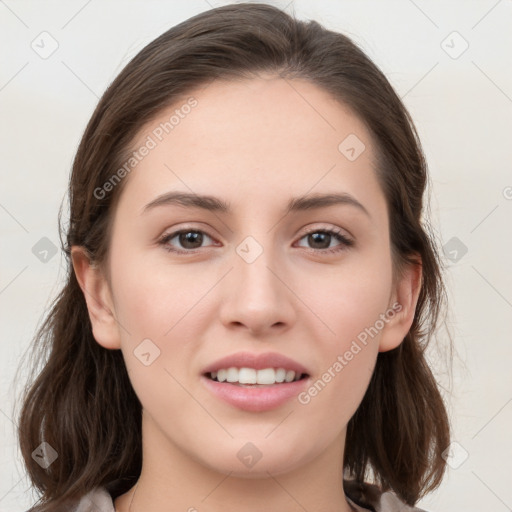 Joyful white young-adult female with long  brown hair and grey eyes